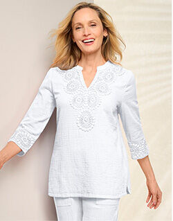 woman wearing white v-neck tunic and white pants