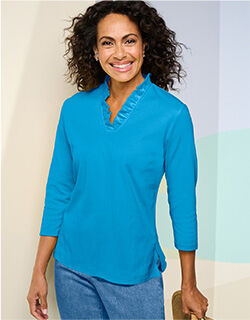 woman wearing blue 3/4 sleeve blouse with ruffle pattern around neck