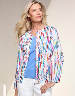 model wearing red, white, and lur patterned jacket over blue top and white pants