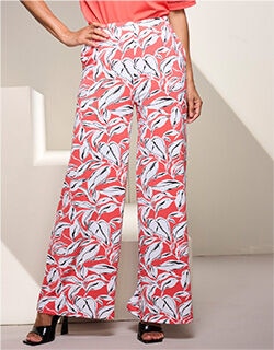 waist-down view of model wearing floral patterned wide leg pants in white, pink and orange
