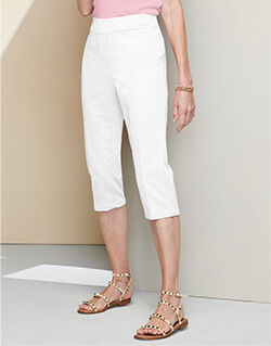 waist-down view of model wearing white capris and beige sandals