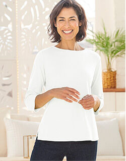 woman wearing white 3/4 sleeve knit top, dark pants