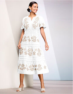 woman wearing white dress with beige floral embroidery patterns