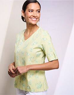model wearing light green floral v-neck shirt