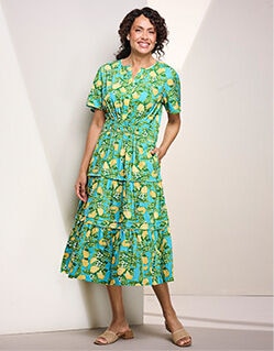 woman wearing green dress with yellow and light blue flowers