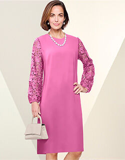 woman wearing light mauve dress holding beige purse