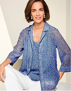 sitting model wearing scattered dots shirts and white pants