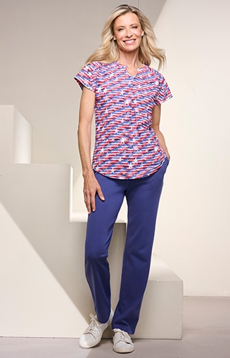 model wearing red, white, blue abstract patterned short sleeve blouse and blue jeans