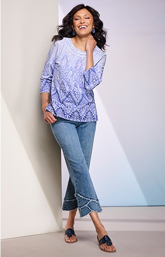 woman wearing light purple blouse and light blue jeans